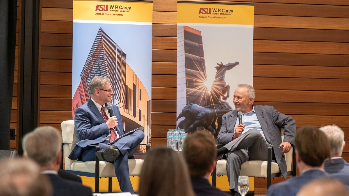 Dean Ohad Kadan and Lawrence H. Summers sitting on a stage in front of a crowd